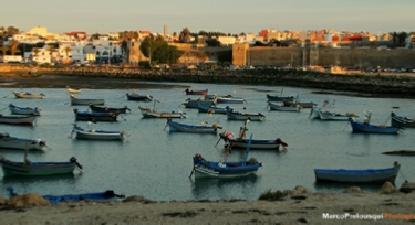 Coast of Asilah and boats . Explore Morocco with Trek Morocco Desert